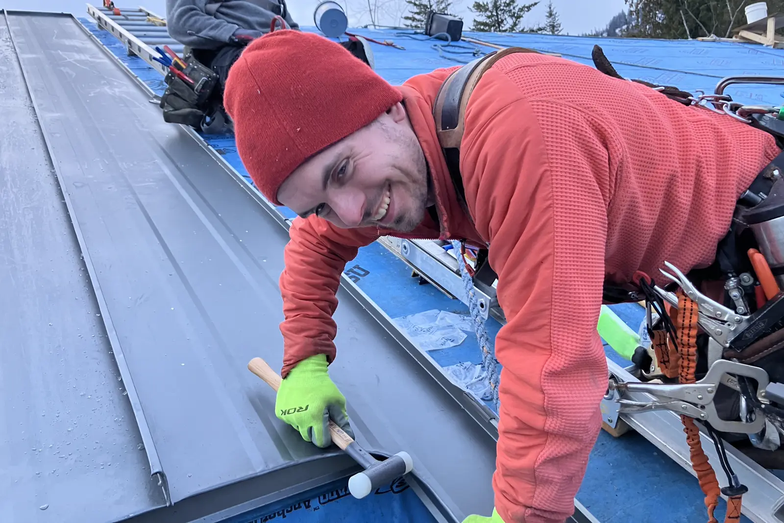 Liam Kinders on-site during a metal roofing project in Kelowna